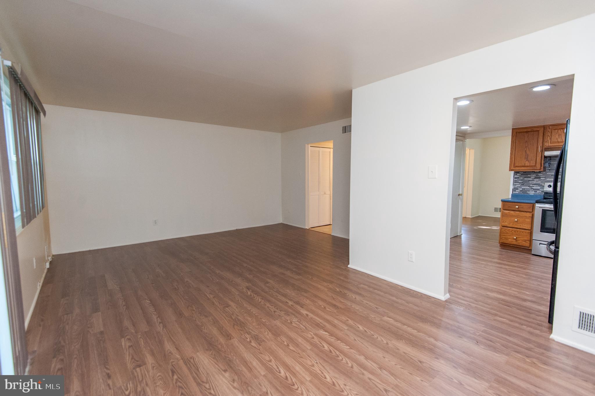 12013 Pheasant Run Drive Laurel, MD 20708 - Photo 10 of 34 a view of a room with wooden floor and a way to kitchen