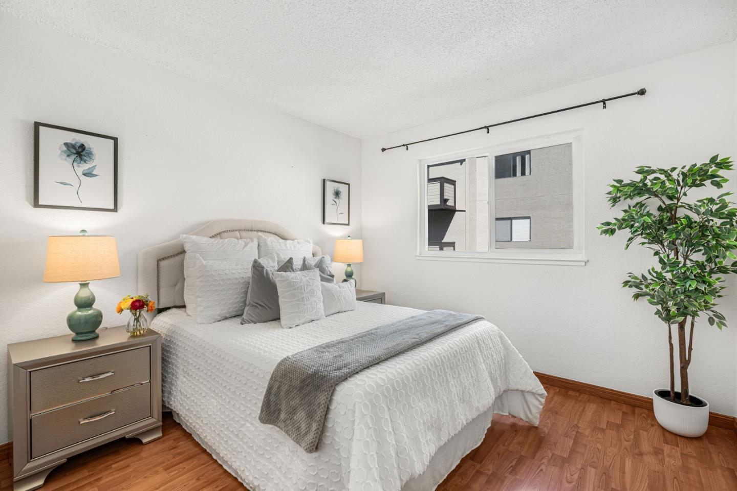 131 Wenatchee Common, Unit 14 Fremont, CA 94539 - Photo 12 of 30 a bedroom with a bed and a potted plant