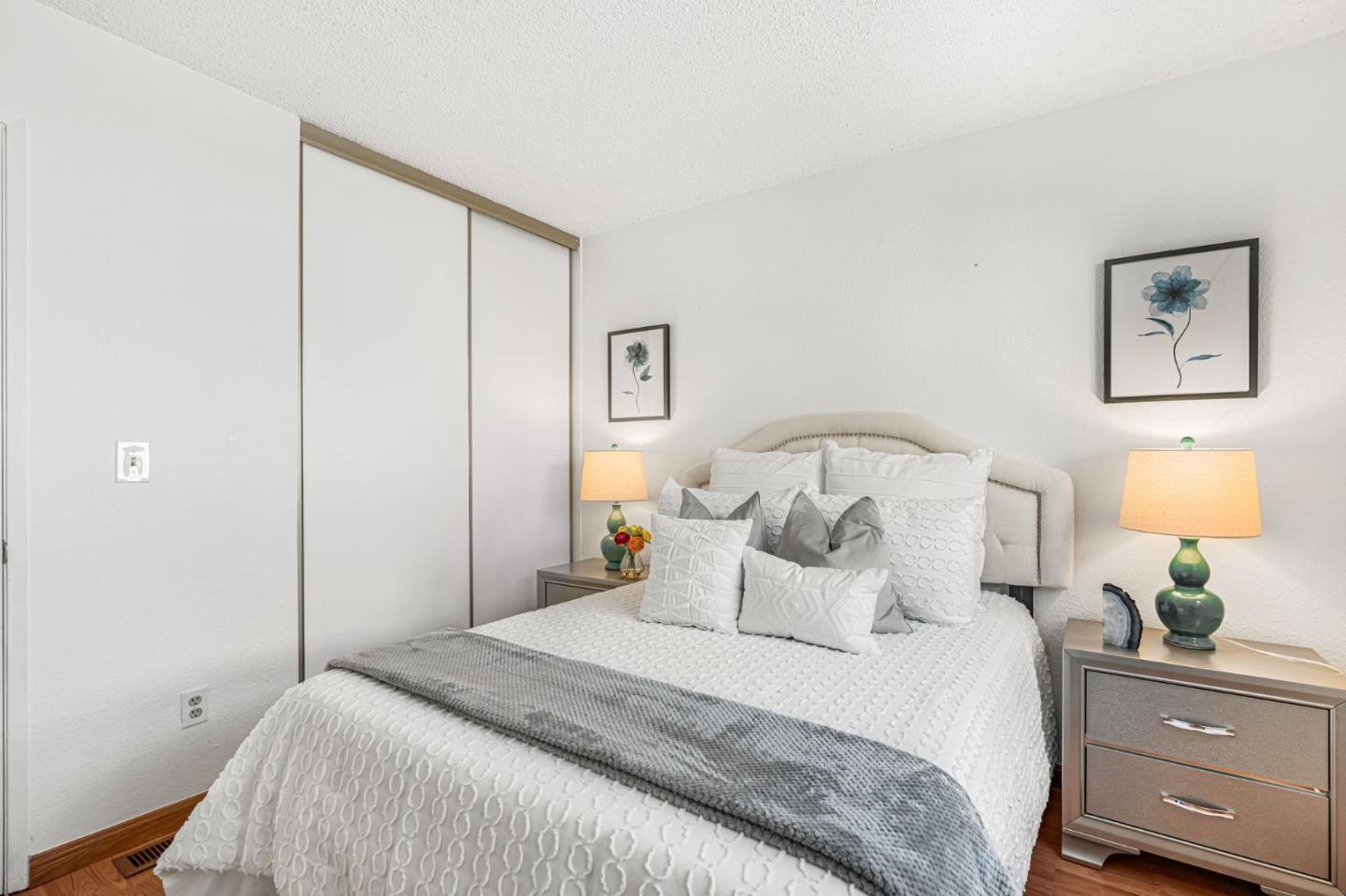 131 Wenatchee Common, Unit 14 Fremont, CA 94539 - Photo 13 of 30 a bedroom with a bed and a lamp on dresser