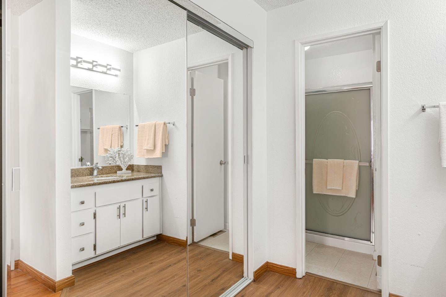 131 Wenatchee Common, Unit 14 Fremont, CA 94539 - Photo 17 of 30 a bathroom with a granite countertop sink a mirror and a shower