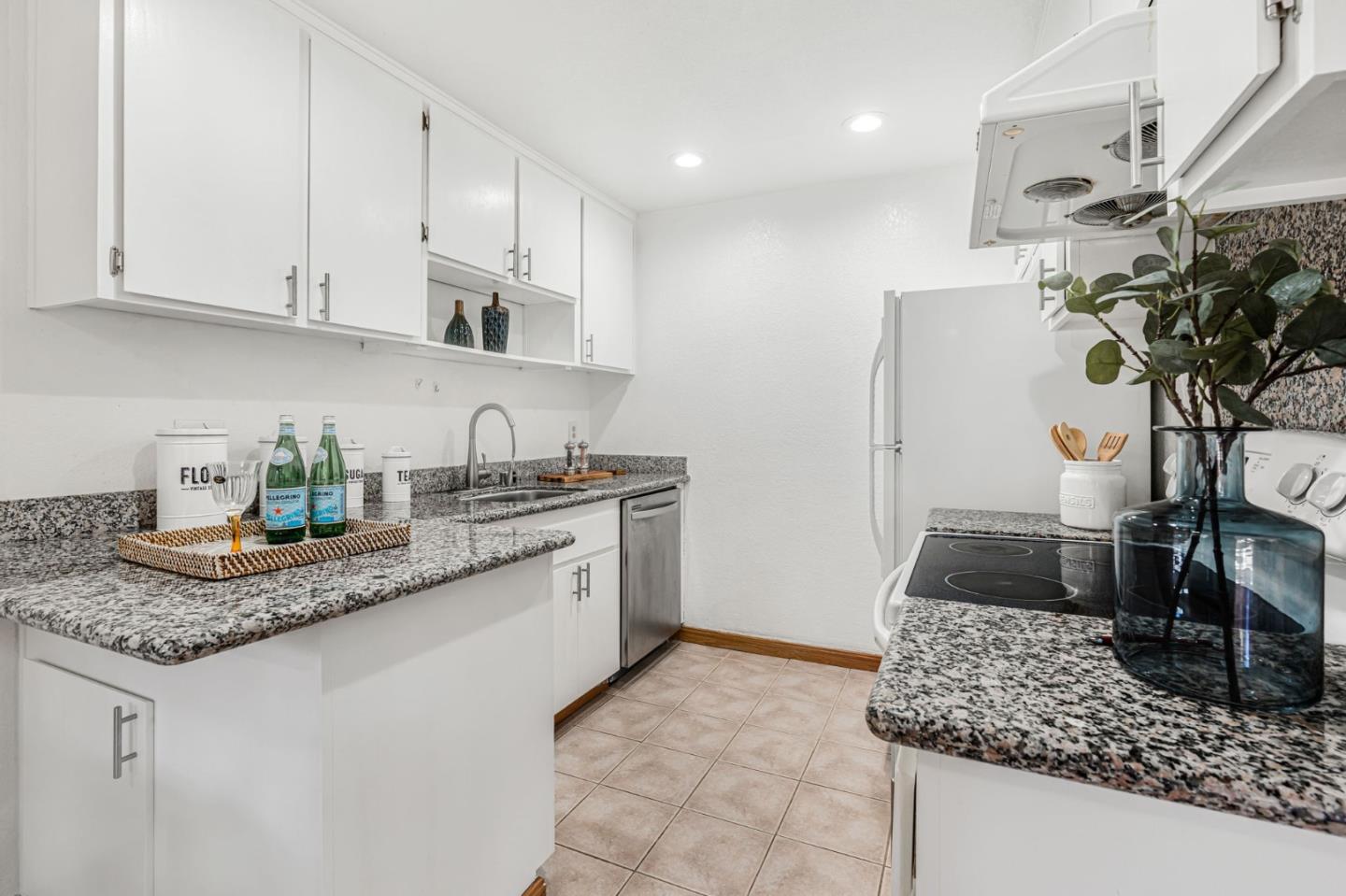 131 Wenatchee Common, Unit 14 Fremont, CA 94539 - Photo 7 of 30 a kitchen with stainless steel appliances granite countertop a sink a stove and a granite counter tops