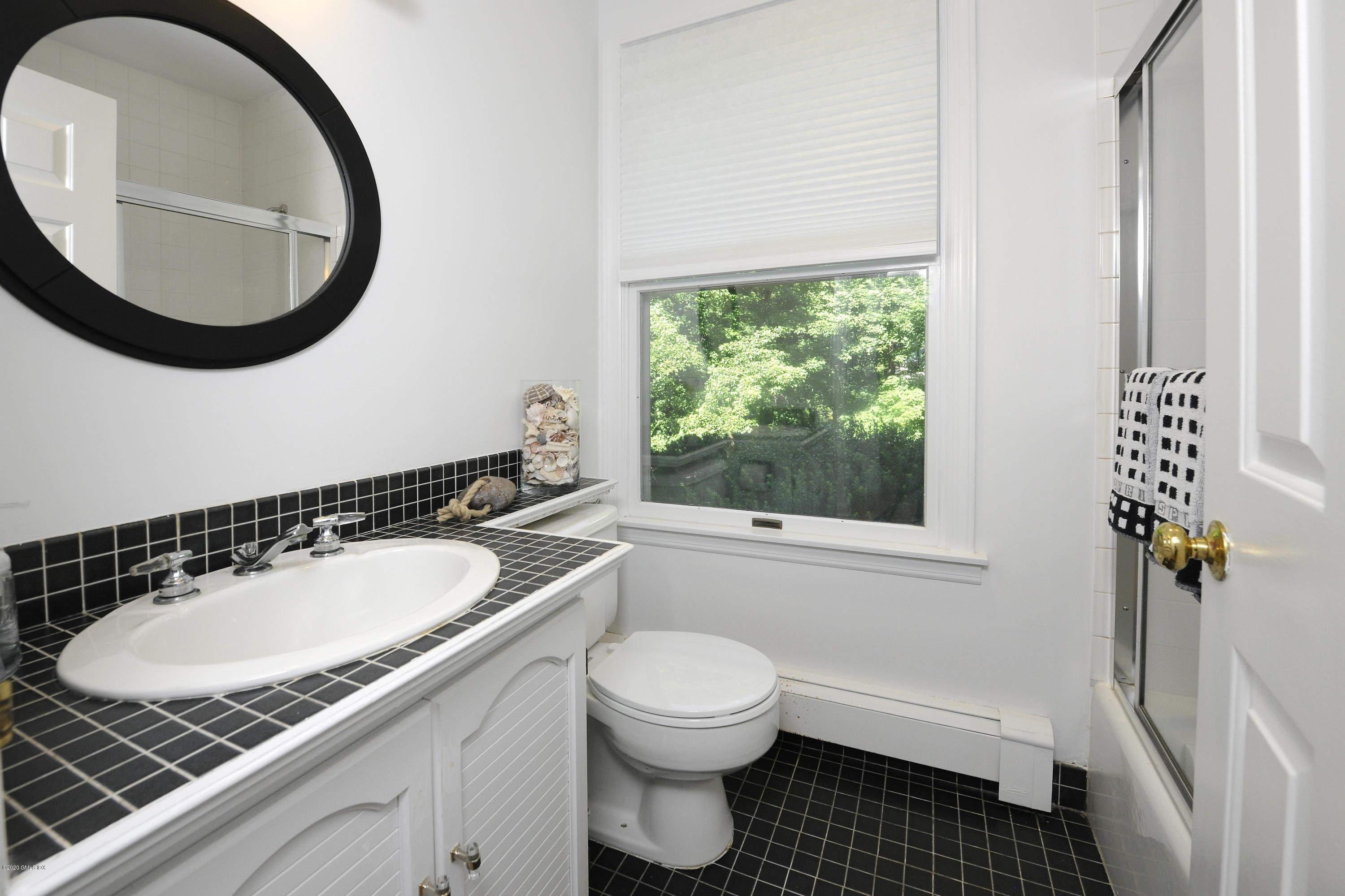 677 River Road Cos Cob, CT 06870 - Photo 11 of 23 a bathroom with a granite countertop toilet a sink and a mirror