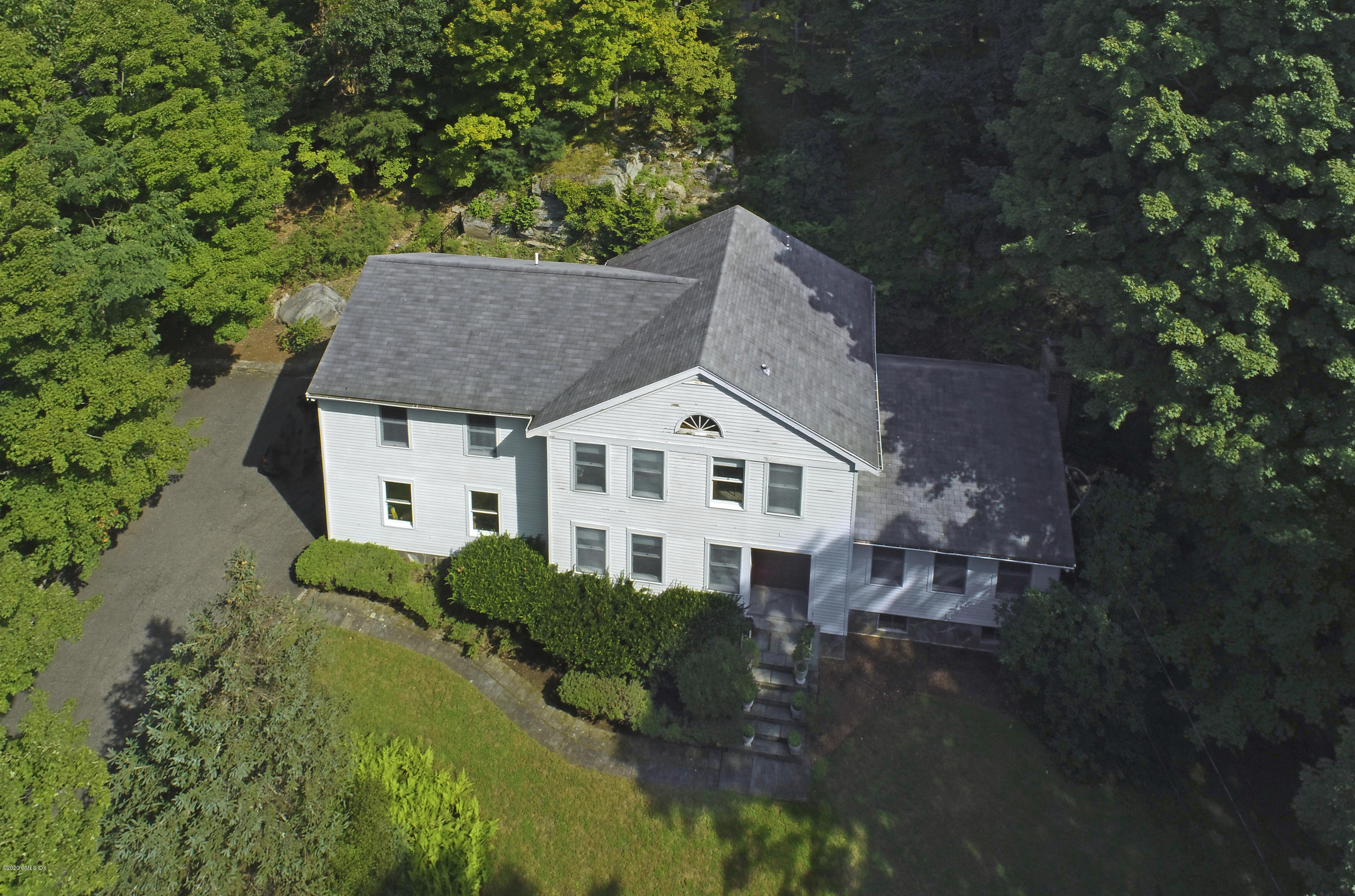 677 River Road Cos Cob, CT 06870 - Photo 2 of 23 a aerial view of a house with a yard and large trees
