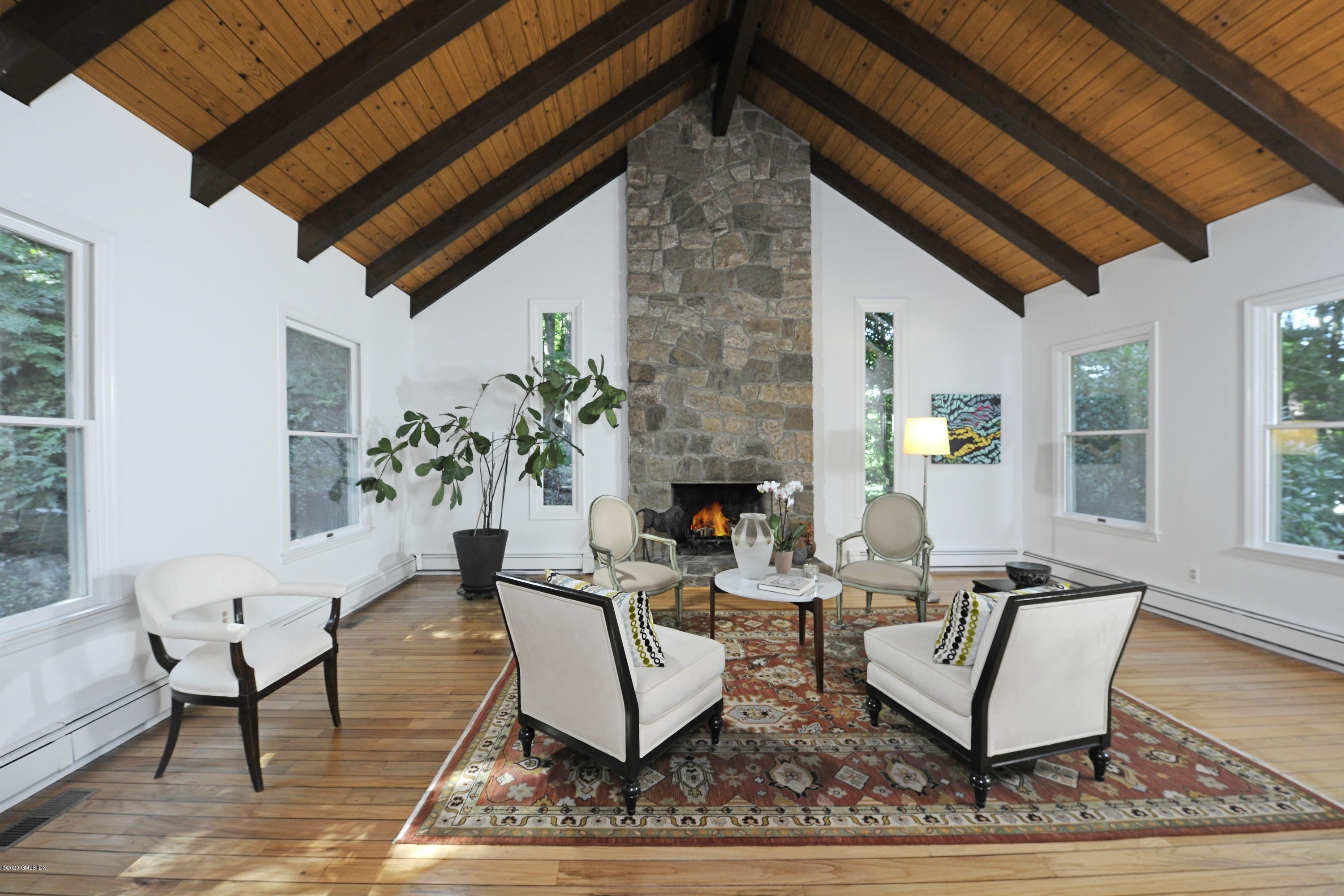 677 River Road Cos Cob, CT 06870 - Photo 5 of 23 a living room with furniture a fireplace and a table