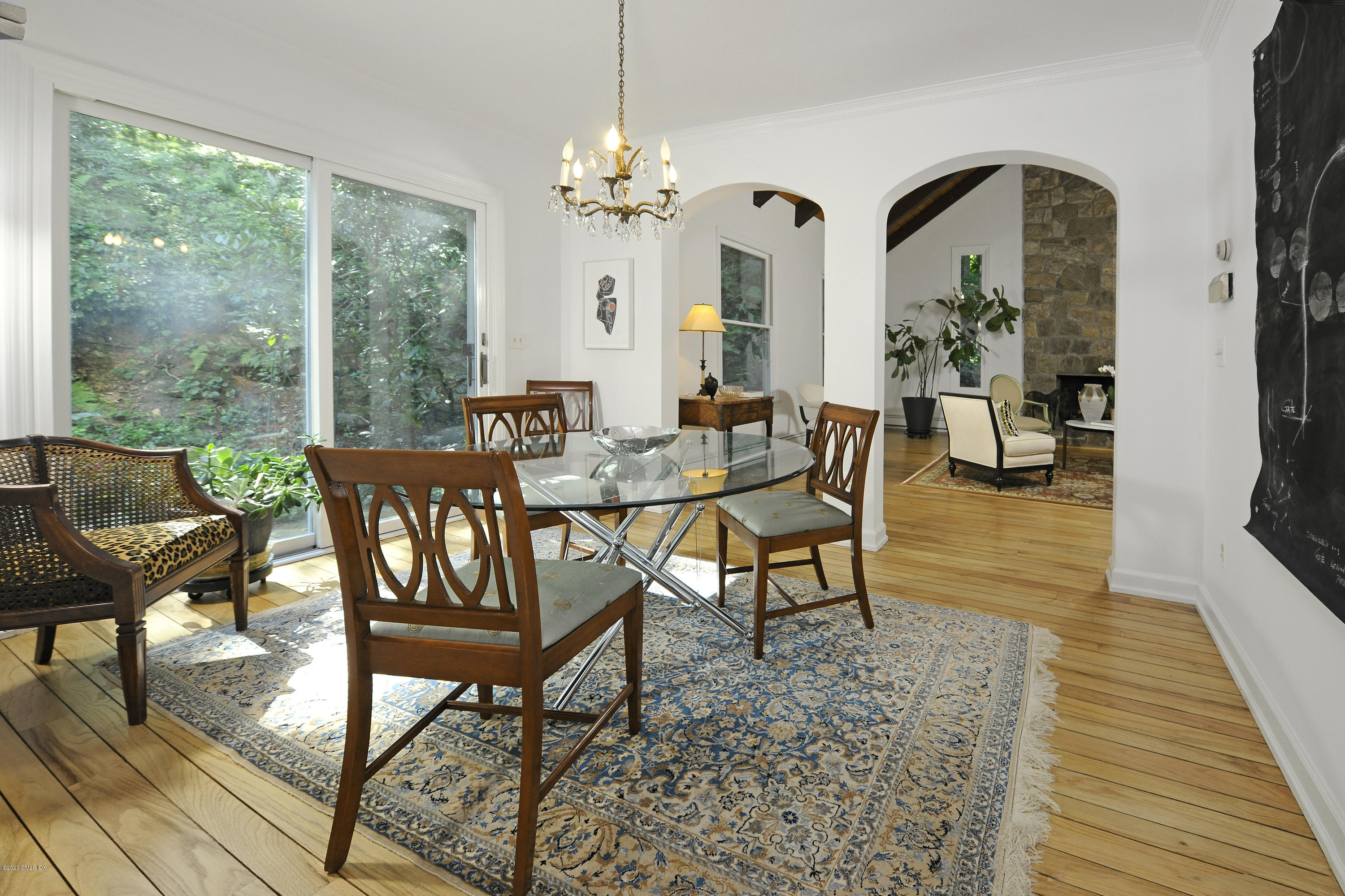 677 River Road Cos Cob, CT 06870 - Photo 7 of 23 a view of a dining room with furniture a chandelier and wooden floor
