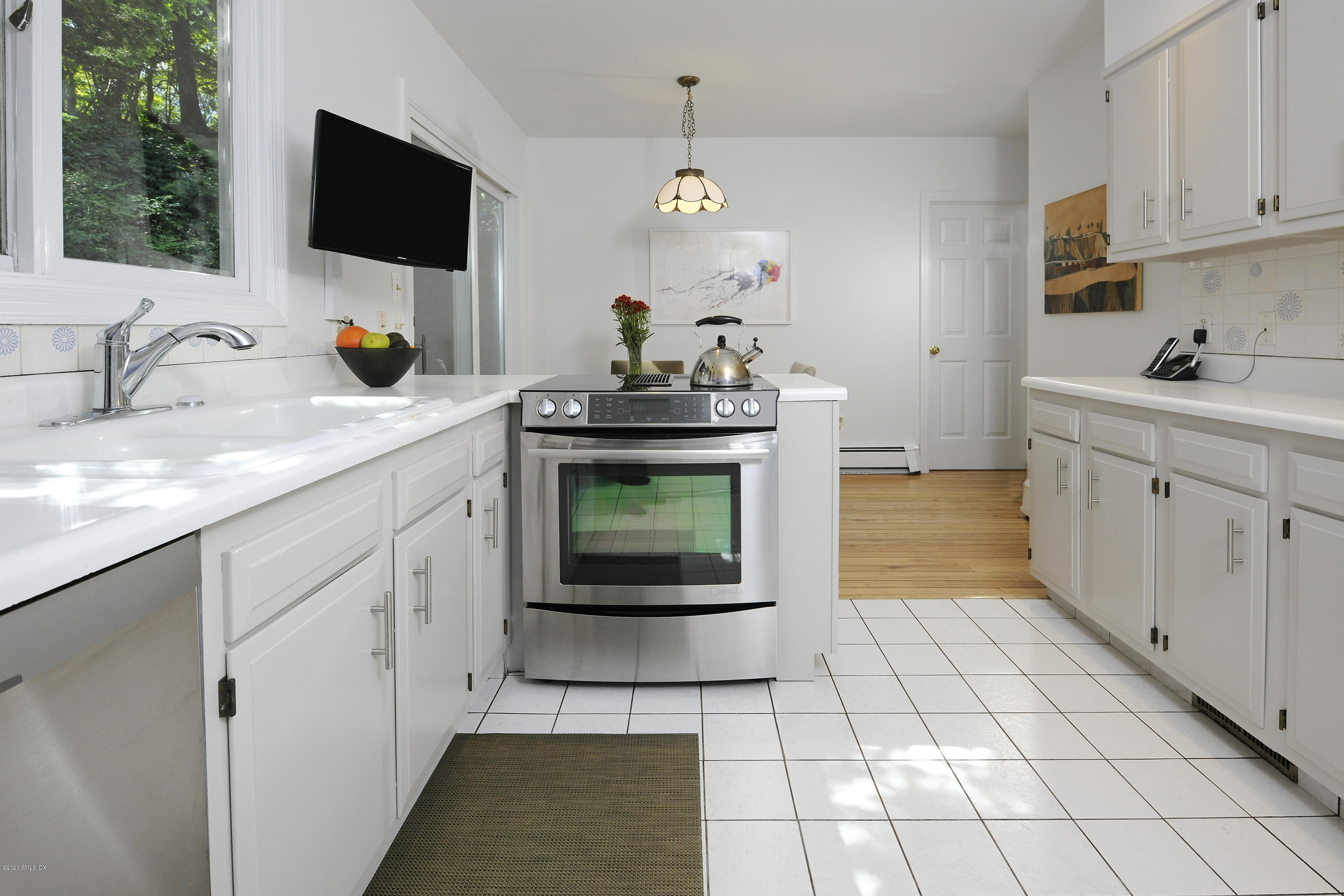 677 River Road Cos Cob, CT 06870 - Photo 9 of 23 a kitchen with stainless steel appliances a stove microwave and sink