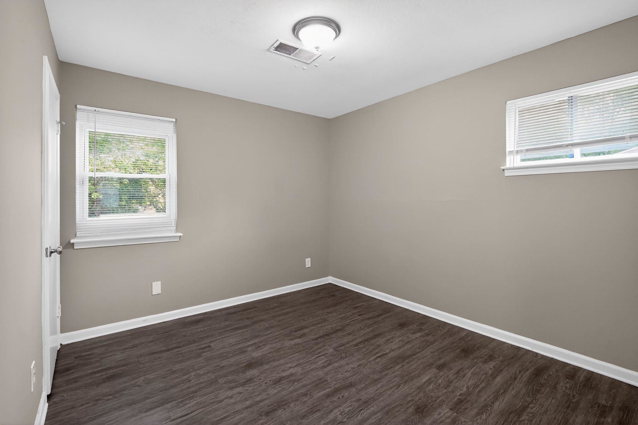 3603 England Street Memphis, TN 38127 - Photo 21 of 36 Unfurnished room featuring baseboards and dark wood-style flooring