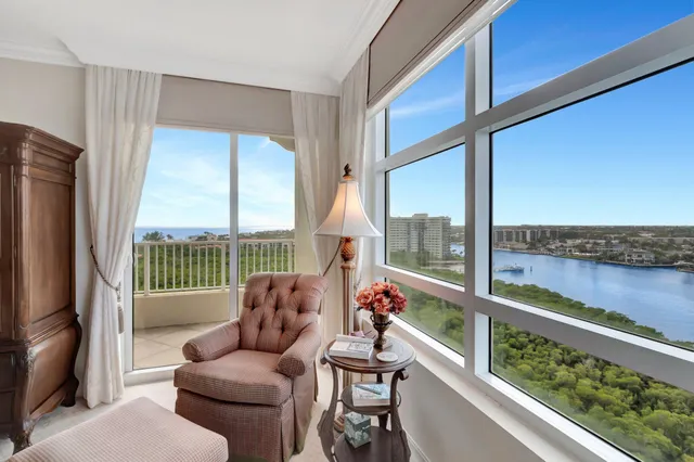 a view of a balcony with chair and floor to ceiling window