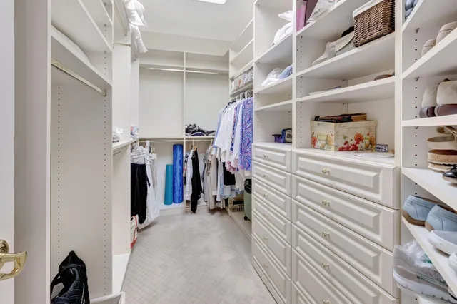 a bedroom with furniture and a large window