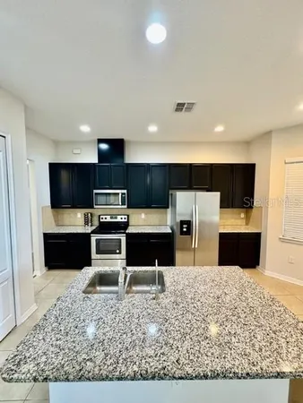a kitchen with a refrigerator and a microwave