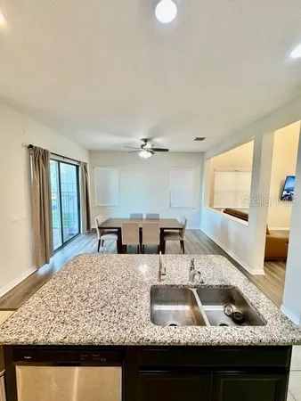 a kitchen with kitchen island granite countertop a sink window and refrigerator