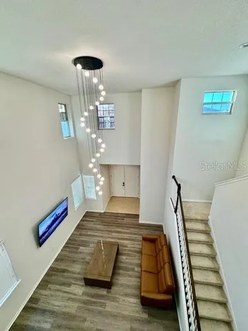 a very nice looking room with wooden floor and furniture