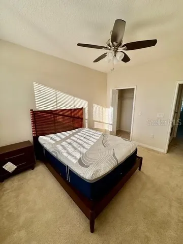 a bed sitting in a bedroom next to a window