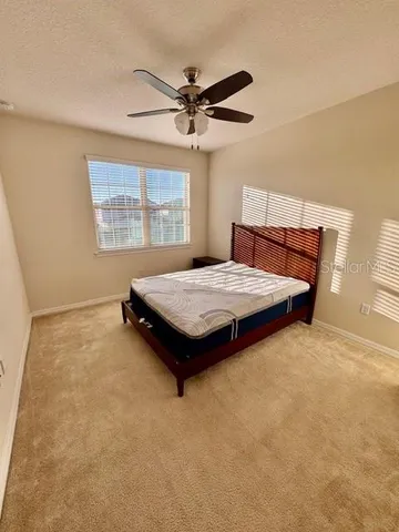 a bedroom with a bed and window