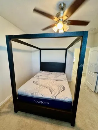 a bedroom with a bed and a mirror