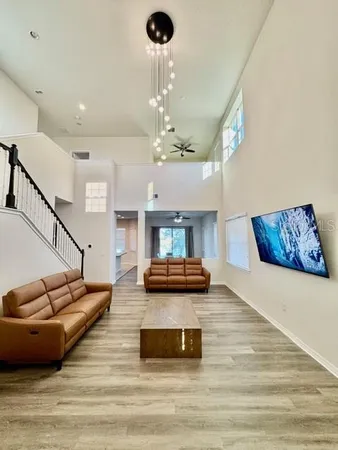 a living room with furniture and a chandelier