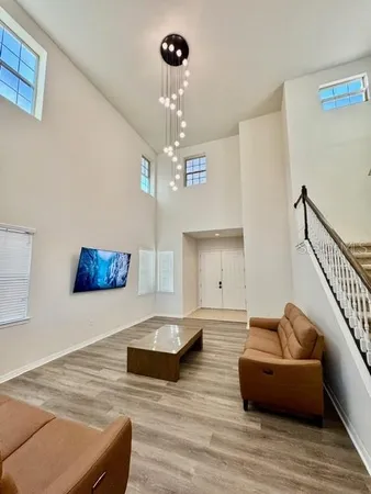 a living room with furniture and a chandelier