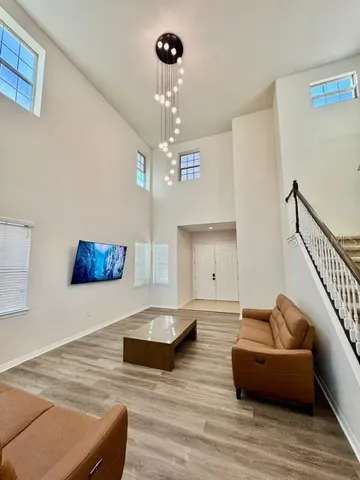 a living room with furniture and a chandelier