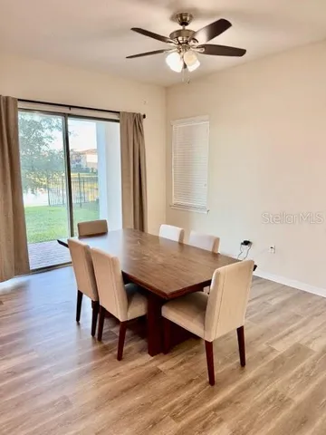 a view of a dining room with furniture window and wooden floor