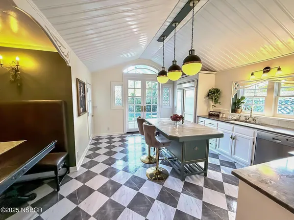 a view of a dining room with a table and chairs