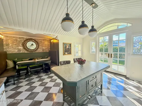 a kitchen with a stove a sink and a chandelier
