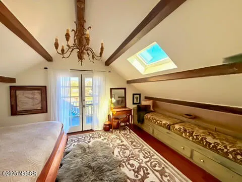 a bedroom with furniture and a large window