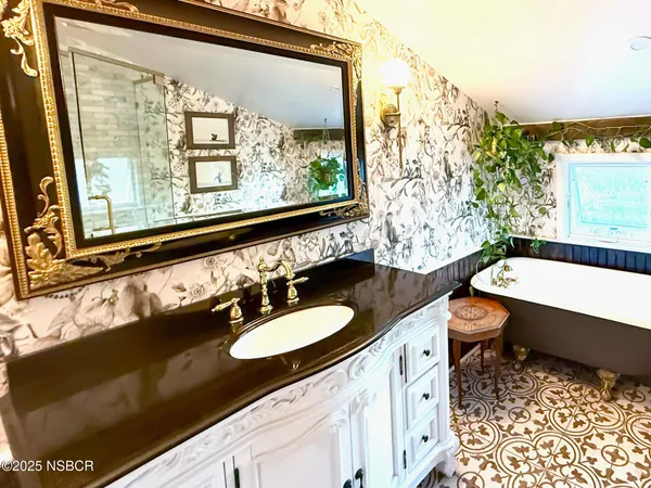 a bathroom with a sink vanity and a mirror