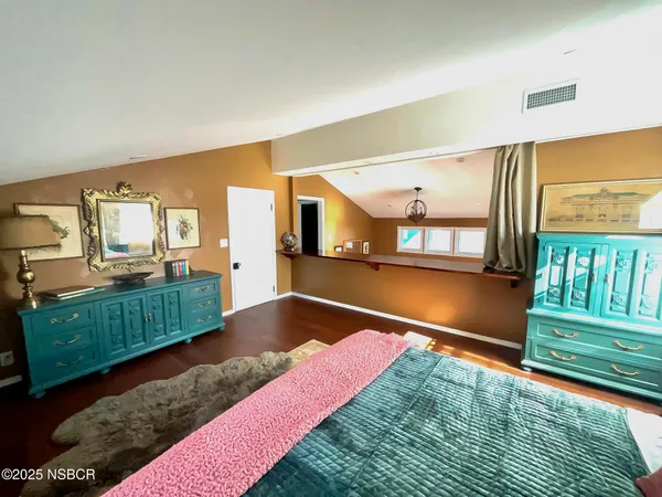 a bedroom with a bed and a view of kitchen