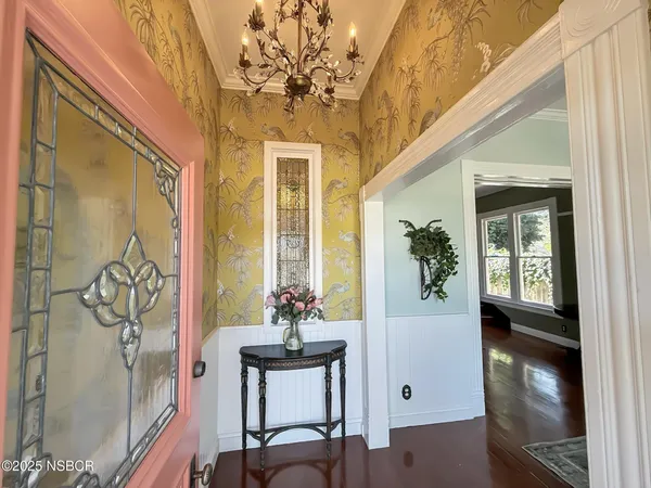 a view of a entryway with furniture and wooden floor