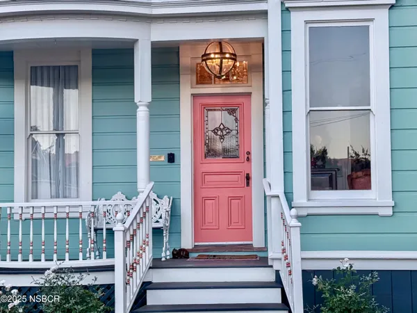 a front view of a house with a front door and porch