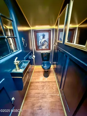 a balcony with couch and wooden floor