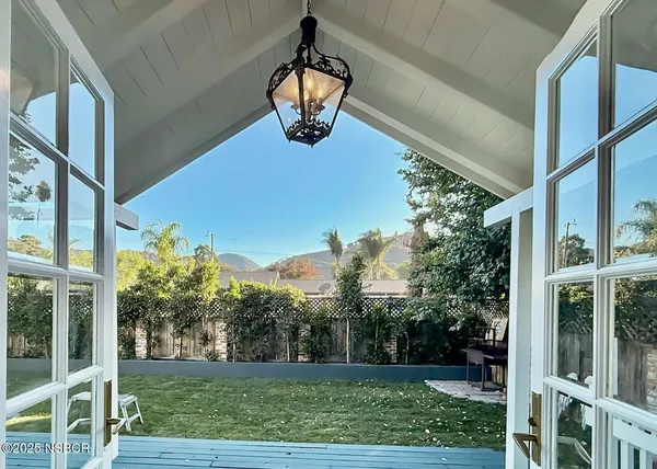 a view of a porch with a yard and potted plants