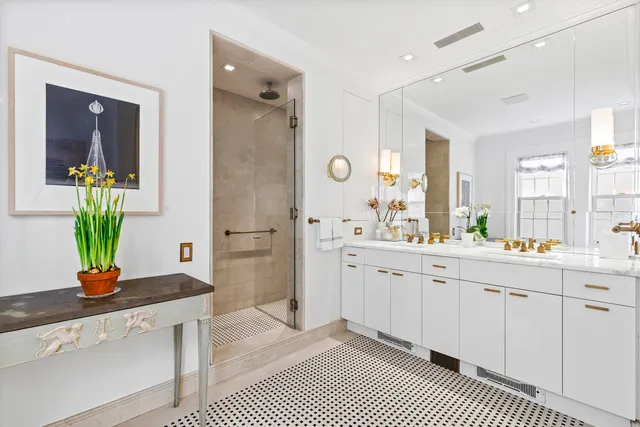 a spacious bedroom with a bed couch and a window