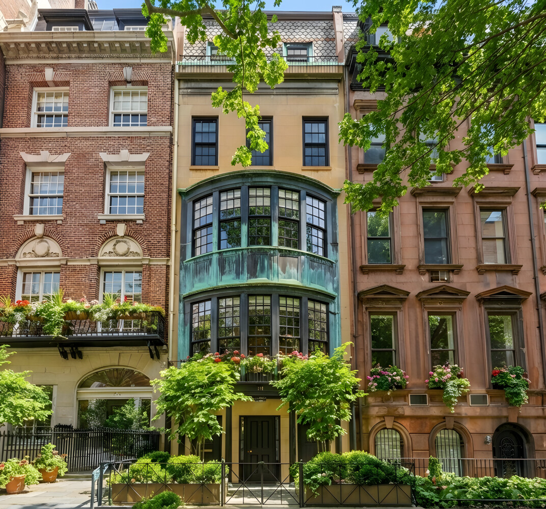 a front view of a residential apartment building with a yard and plants