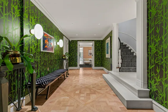 a front view of a residential apartment building with a yard and plants