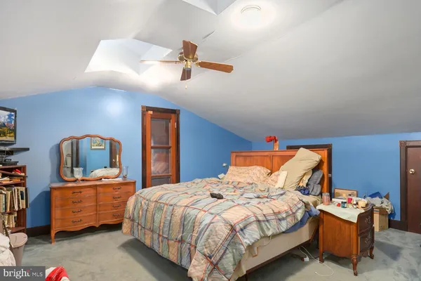a bedroom with a bed and dresser