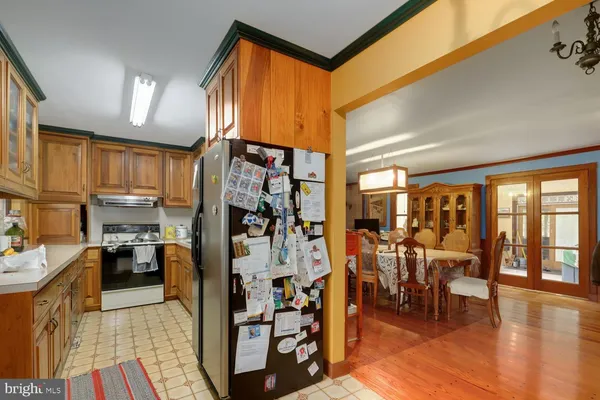 a kitchen with stainless steel appliances lots of counter top space and furniture