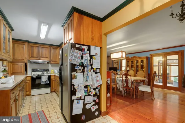 a kitchen with stainless steel appliances lots of counter top space and furniture