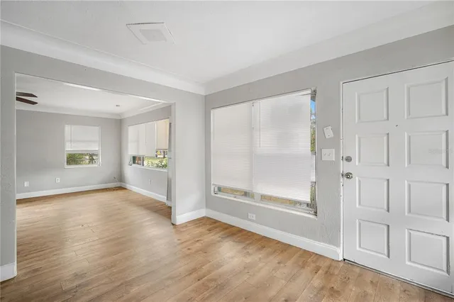wooden floor in an empty room with a window