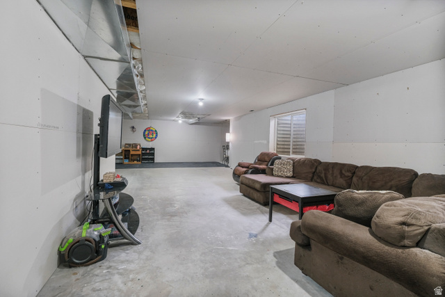 860 West 2980th Street South Logan, UT 84321 - Photo 32 of 38 Expansive finished basement featuring concrete flooring and white walls, with recessed lighting and a window with horizontal blinds
