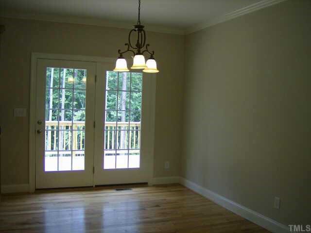 135 Piney Forest Road Roxboro, NC 27574 - Photo 2 of 10 a view of a room with wooden floor chandeliers and kitchen
