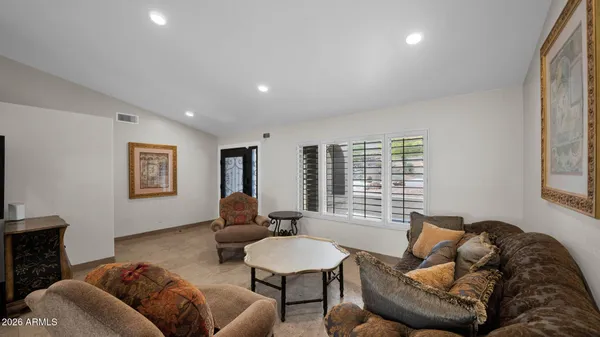 a living room with furniture and a chandelier