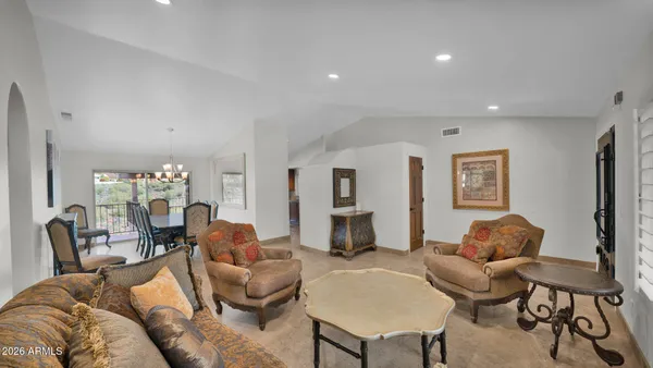 a dining room with furniture a chandelier and wooden floor
