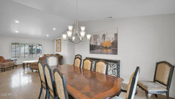 a view of a dining room with furniture window and a chandelier