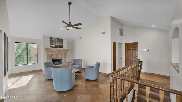 a dining room with furniture a chandelier and wooden floor