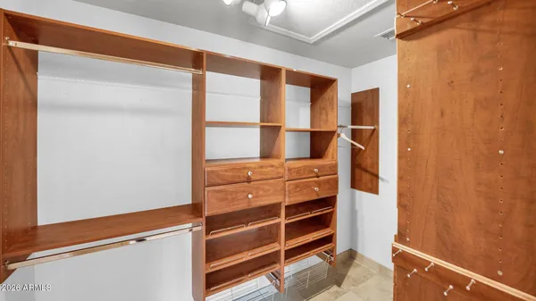 a view of a terrace with furniture and a floor to ceiling window