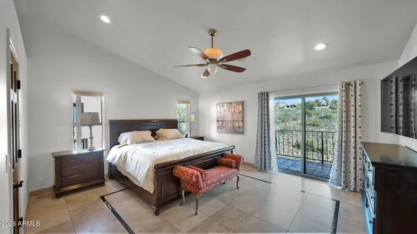 an aerial view of a house with a yard and mountain view in back