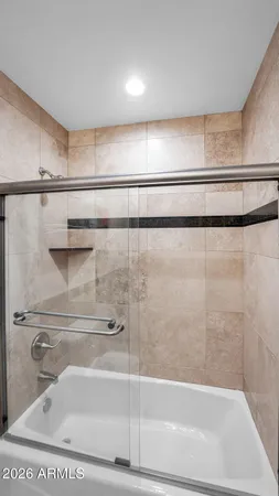 a bathroom with a shower and a sink