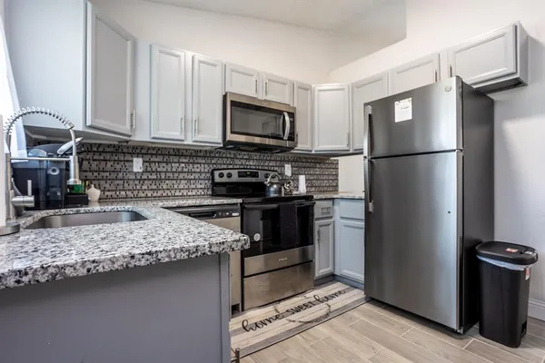 a kitchen with a refrigerator stove and sink