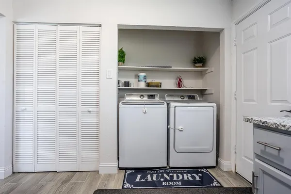 a kitchen with a stove and white cabinets